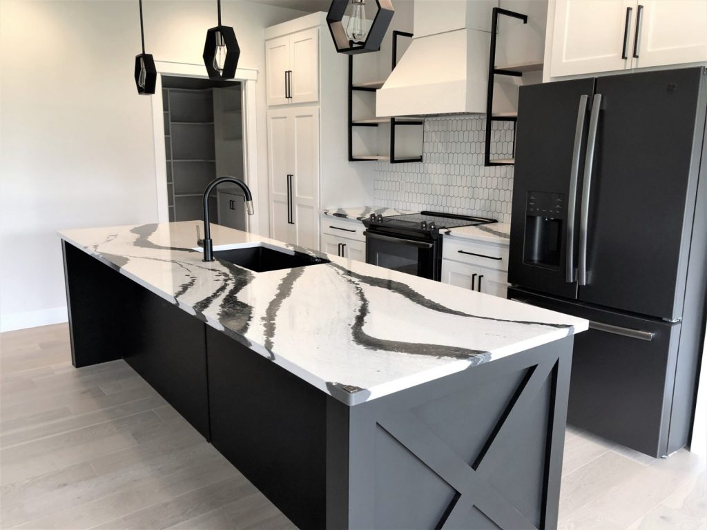 Modern kitchen with bold veined quartz island and matte black fixtures