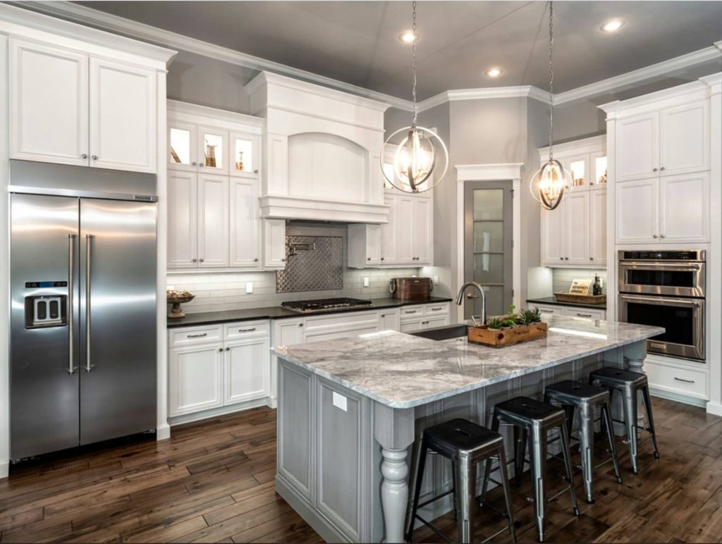 Marble kitchen island with pendant lights in Jacksonville FL home