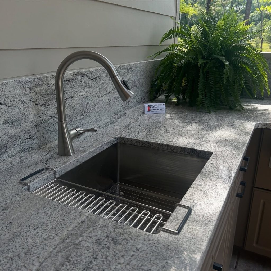 Outdoor kitchen in Florida featuring granite countertops and covered entertainment area